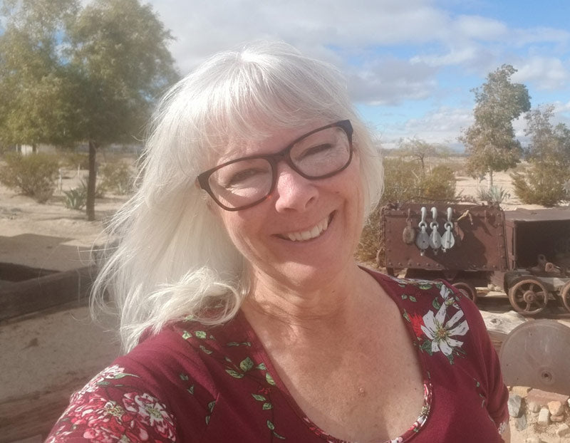 Lori LeVoir outside in a desert landscape