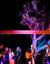 Musicians on an outdoor stage with a Joshua tree behind them